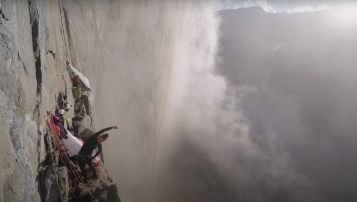 woman stretching on cloudy cliffside